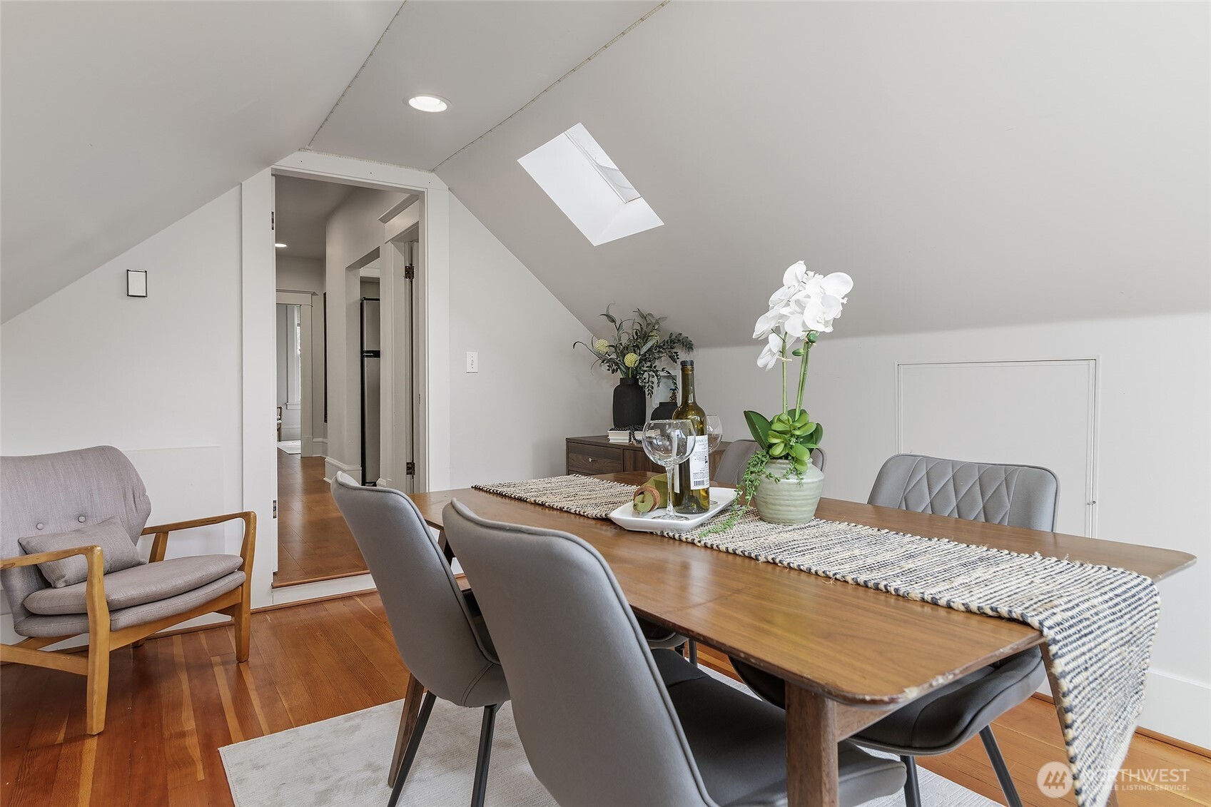 3624 Whitman Avenue North, Unit 4 Seattle, WA 98103 - Photo 18 of 39 a dining room with furniture and wooden floor