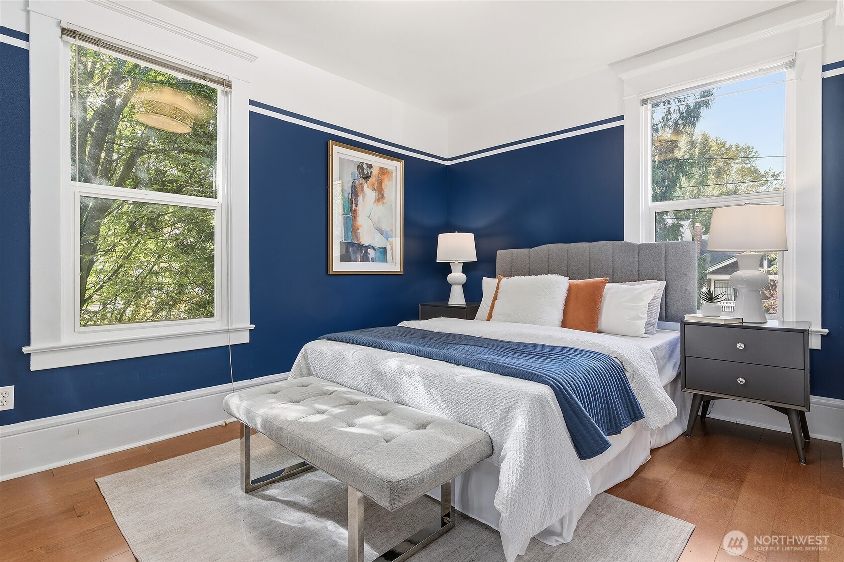 3624 Whitman Avenue North, Unit 4 Seattle, WA 98103 - Photo 20 of 39 a bedroom with a bed and wooden floor