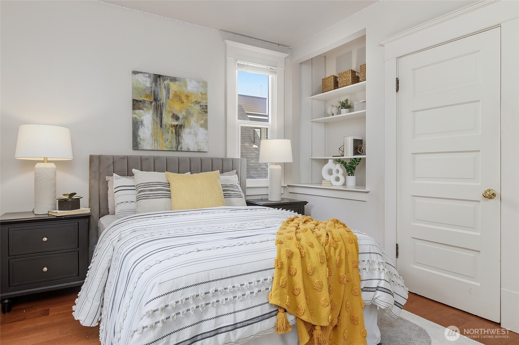 3624 Whitman Avenue North, Unit 4 Seattle, WA 98103 - Photo 26 of 39 a bedroom with a bed and wooden floor