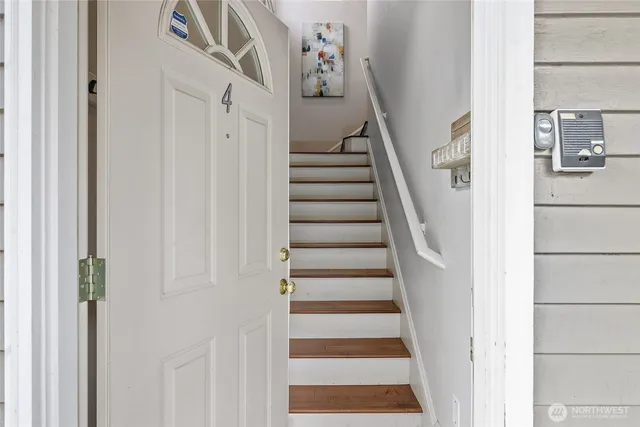 a view of a hallway with wooden floor and entryway