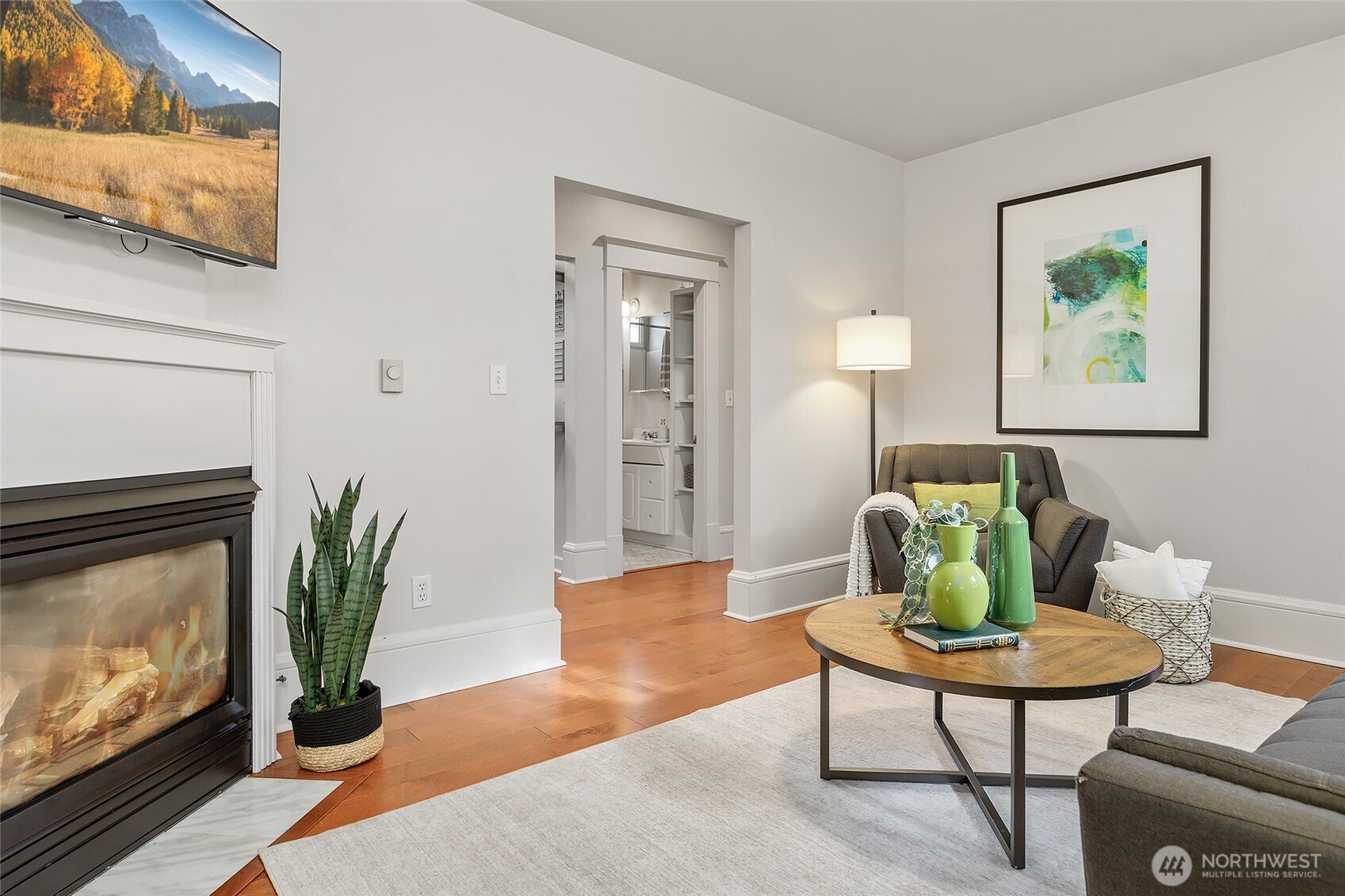 3624 Whitman Avenue North, Unit 4 Seattle, WA 98103 - Photo 8 of 39 a living room with furniture a potted plant and a fireplace