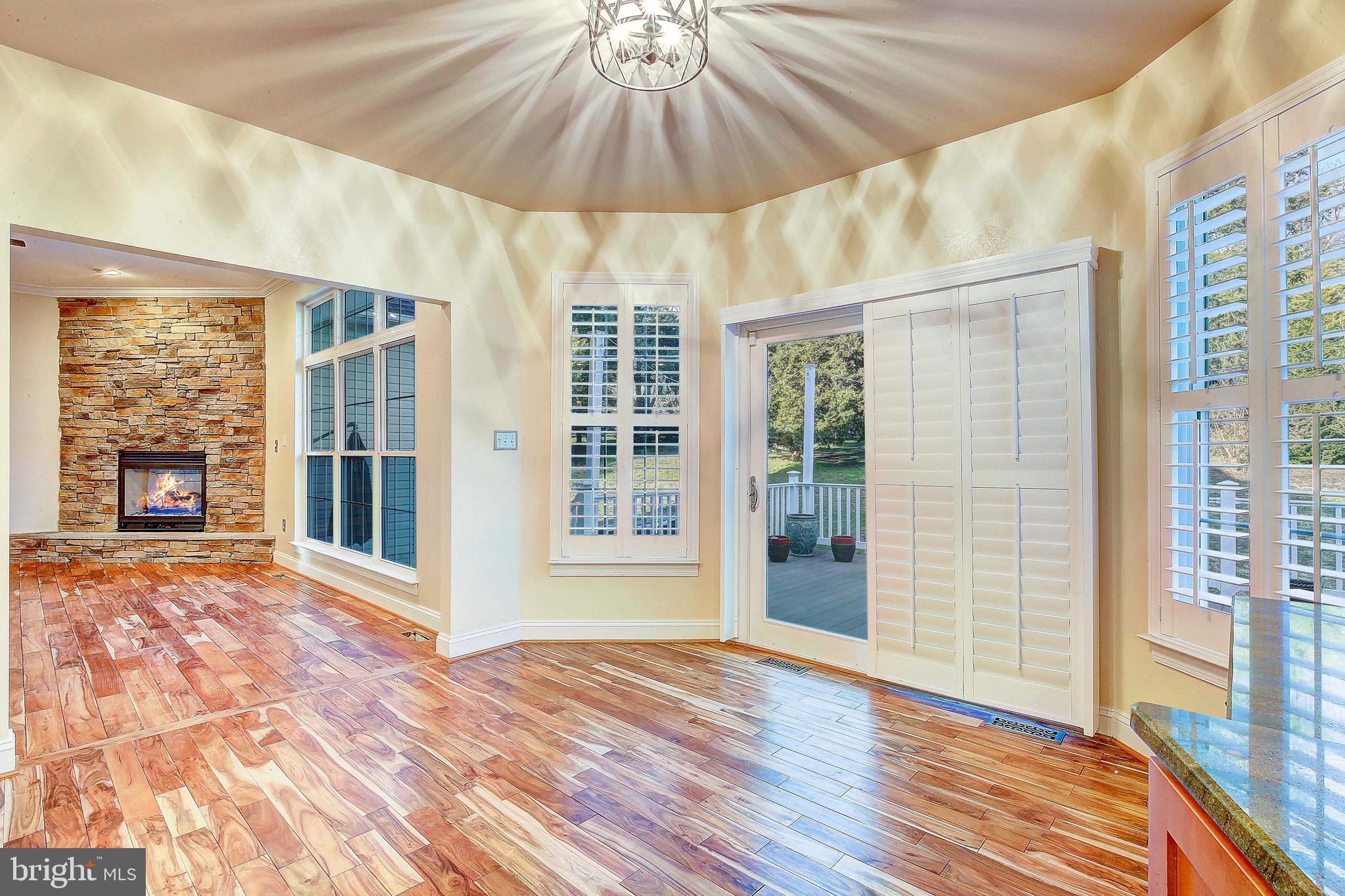 3300 Holland Cliffs Road Huntingtown, MD 20639 - Photo 40 of 93 a view of a room with wooden floor and a ceiling fan