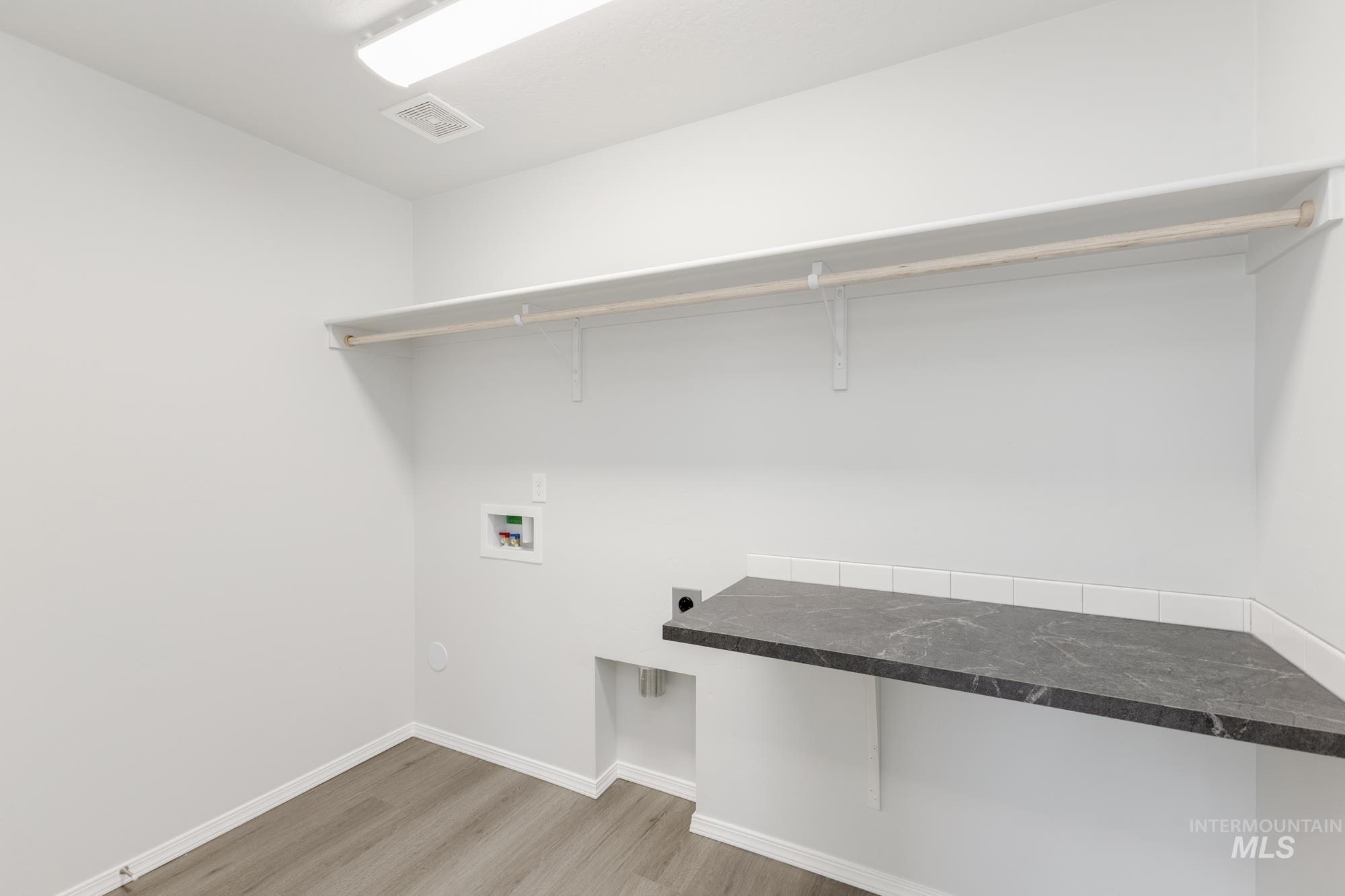13668 Judson Street Caldwell, ID 83607 - Photo 11 of 17 Laundry area featuring light wood-type flooring, hookup for an electric dryer, and washer hookup
