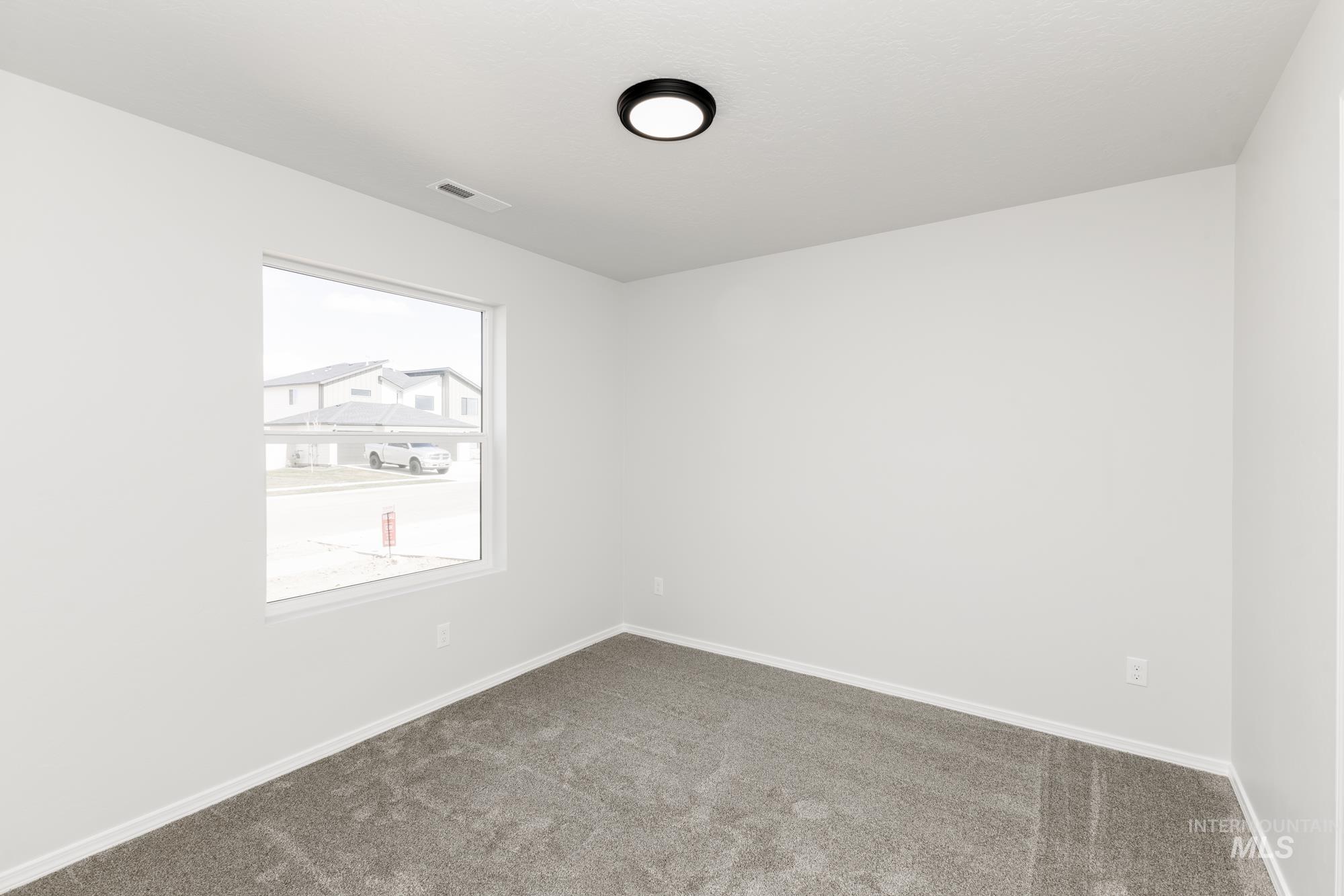 13668 Judson Street Caldwell, ID 83607 - Photo 8 of 17 Empty room featuring carpet flooring and baseboards