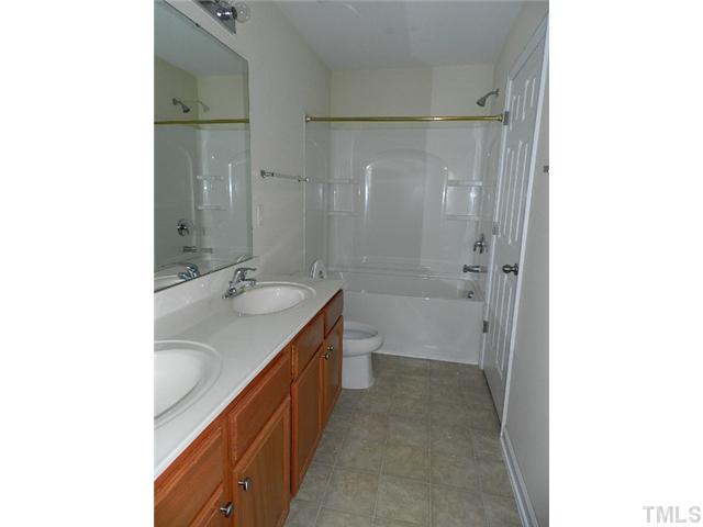 8020 River Watch Lane Raleigh, NC 27616 - Photo 4 of 10 a bathroom with a sink a toilet and shower