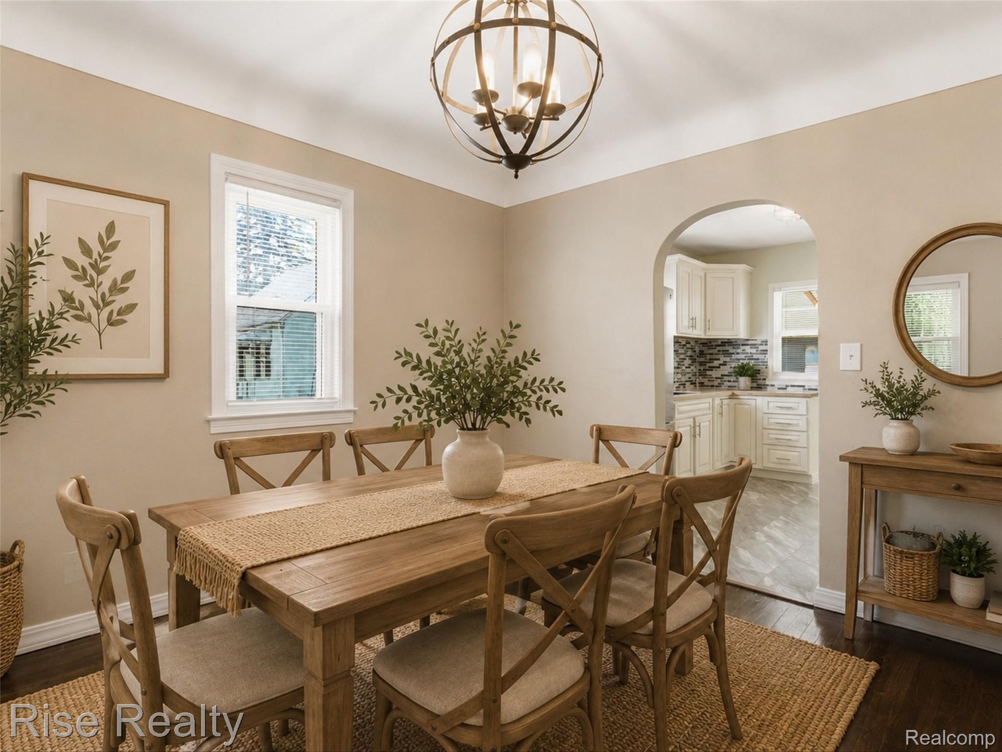 2449 North Genesee Road Burton, MI 48509 - Photo 11 of 40 Dining area featuring a wood-finish floor, arched entryway, and white trim