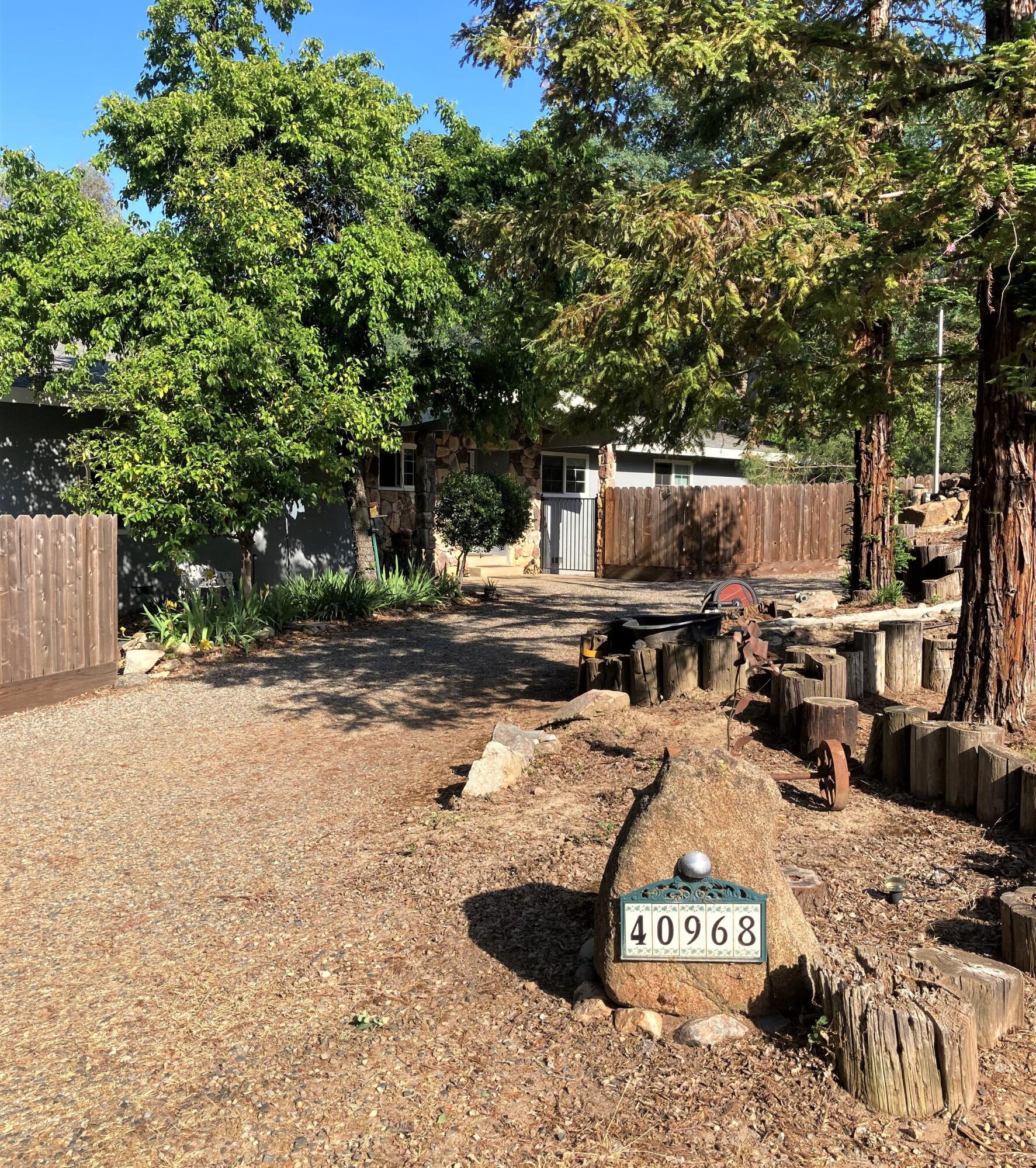 40968 Grouse Drive Three Rivers, CA 93271 - Photo 30 of 31 a view of backyard with a table and chairs under an umbrella
