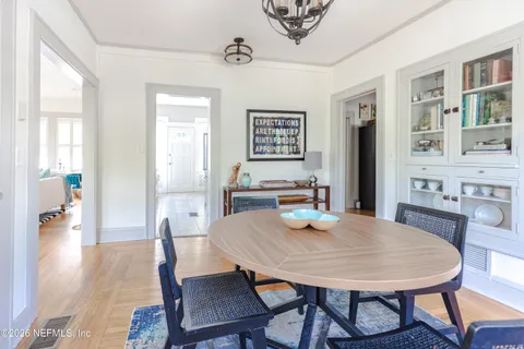 a large white kitchen with stainless steel appliances a refrigerator a stove and a sink with large window