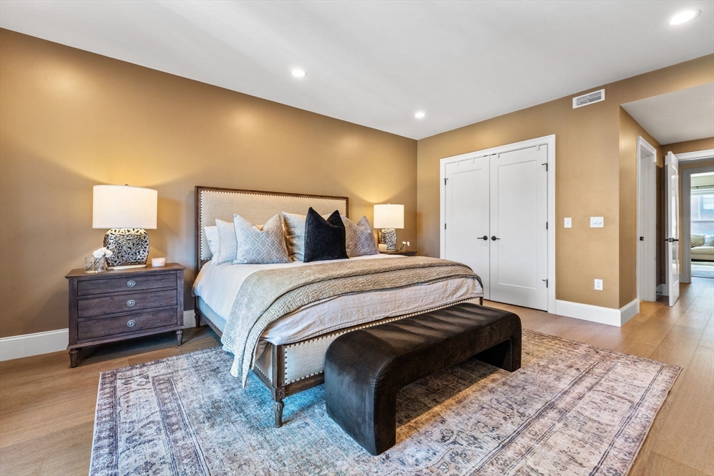 258-260 West 3rd Street, Unit 1 Boston, MA 02127 - Photo 17 of 37 a spacious bedroom with a bed and wooden floor