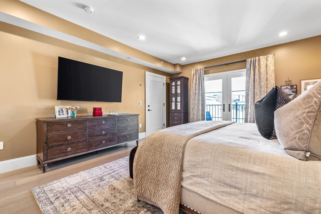 258-260 West 3rd Street, Unit 1 Boston, MA 02127 - Photo 18 of 37 a bedroom with a bed and a flat screen tv