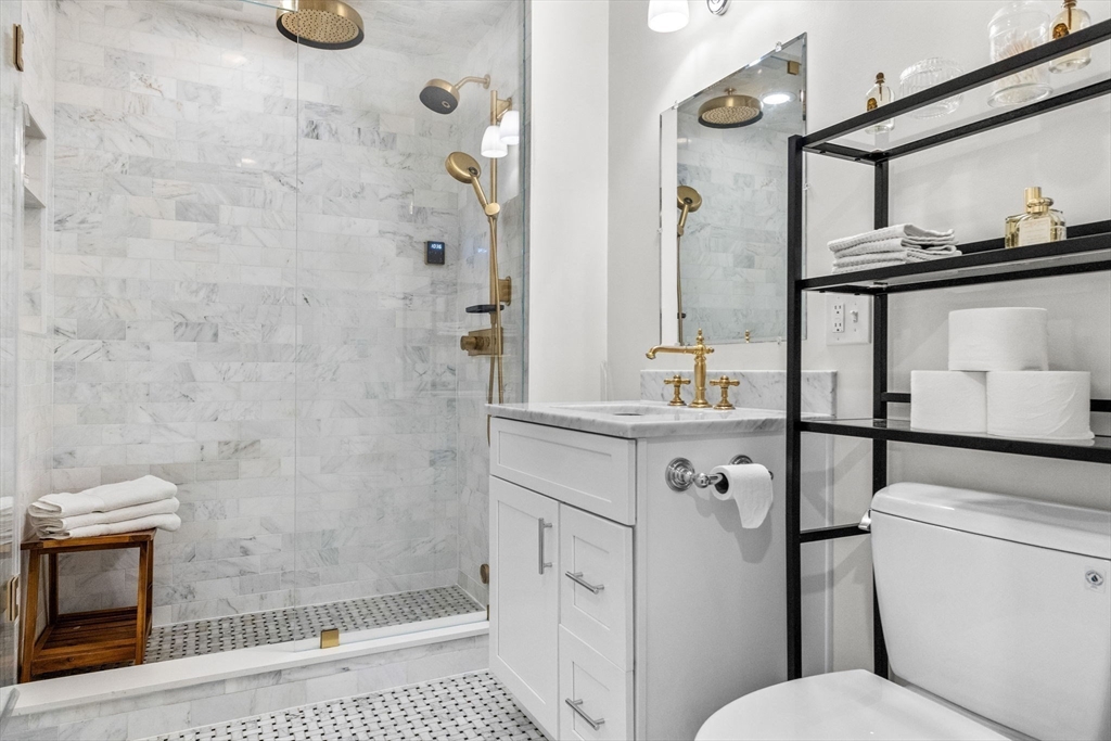 258-260 West 3rd Street, Unit 1 Boston, MA 02127 - Photo 21 of 37 a bathroom with a granite countertop sink toilet and shower