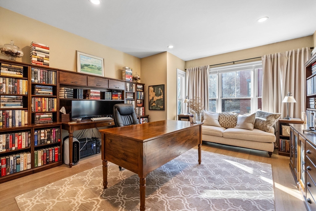 258-260 West 3rd Street, Unit 1 Boston, MA 02127 - Photo 26 of 37 a living room with furniture and a book shelf