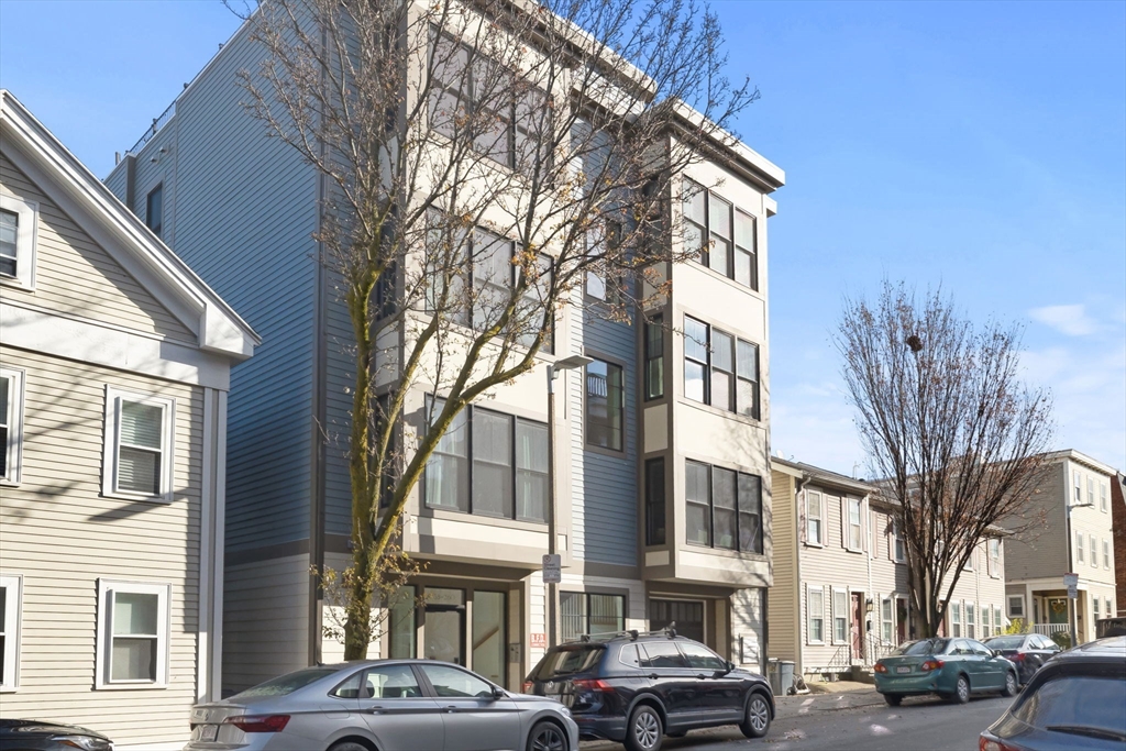 258-260 West 3rd Street, Unit 1 Boston, MA 02127 - Photo 34 of 37 a front view of a building with lot of cars and trees