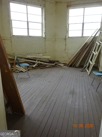 a view of a room with wooden floor
