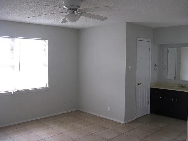 4004 Vicky Street Big Spring, TX 79720 - Photo 3 of 13 Room featuring a window with blinds, ceiling fan, and tiled flooring