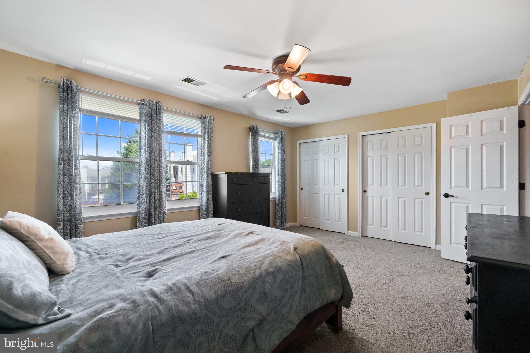 11279 Kessler Place Manassas, VA 20109 - Photo 23 of 39 a spacious bedroom with a bed and a chandelier