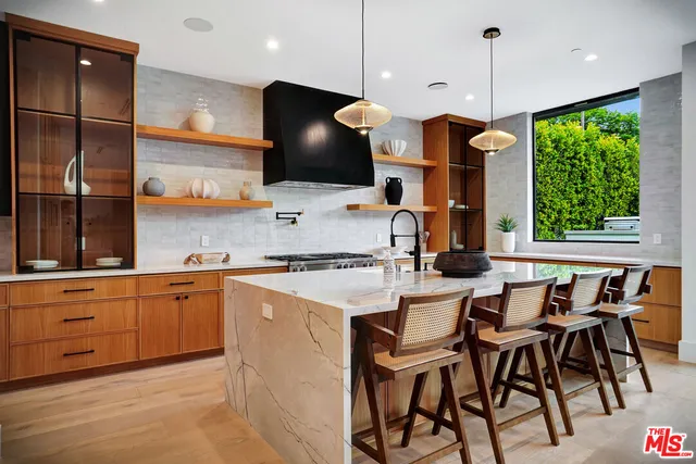 a view of a entryway door with hallway and a potted plant