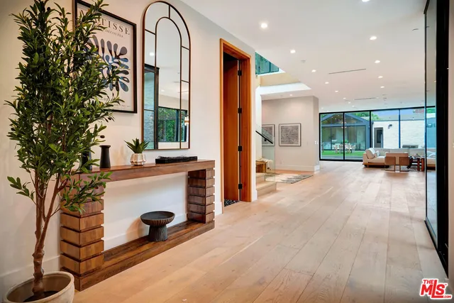 a view of a patio with table and chairs and potted plants