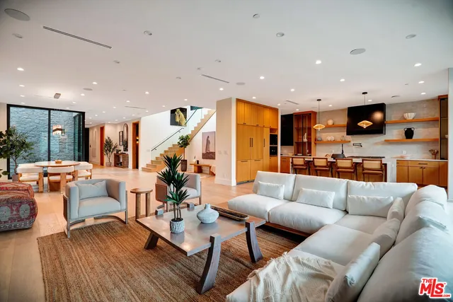 a kitchen with stainless steel appliances granite countertop a refrigerator a sink and a stove