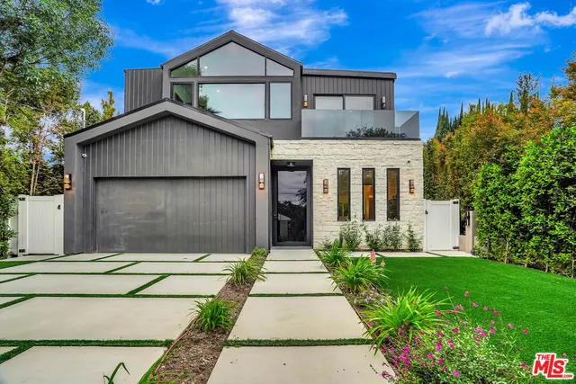 a kitchen with stainless steel appliances a sink and a stove