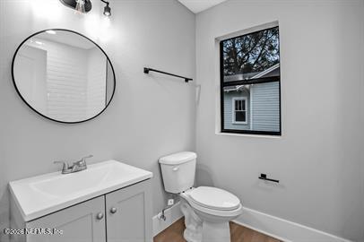 2125 Gilmore Street Jacksonville, FL 32204 - Photo 15 of 18 a bathroom with a toilet a sink and mirror