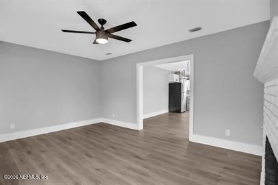 2125 Gilmore Street Jacksonville, FL 32204 - Photo 6 of 18 an empty room with wooden floor and ceiling fan