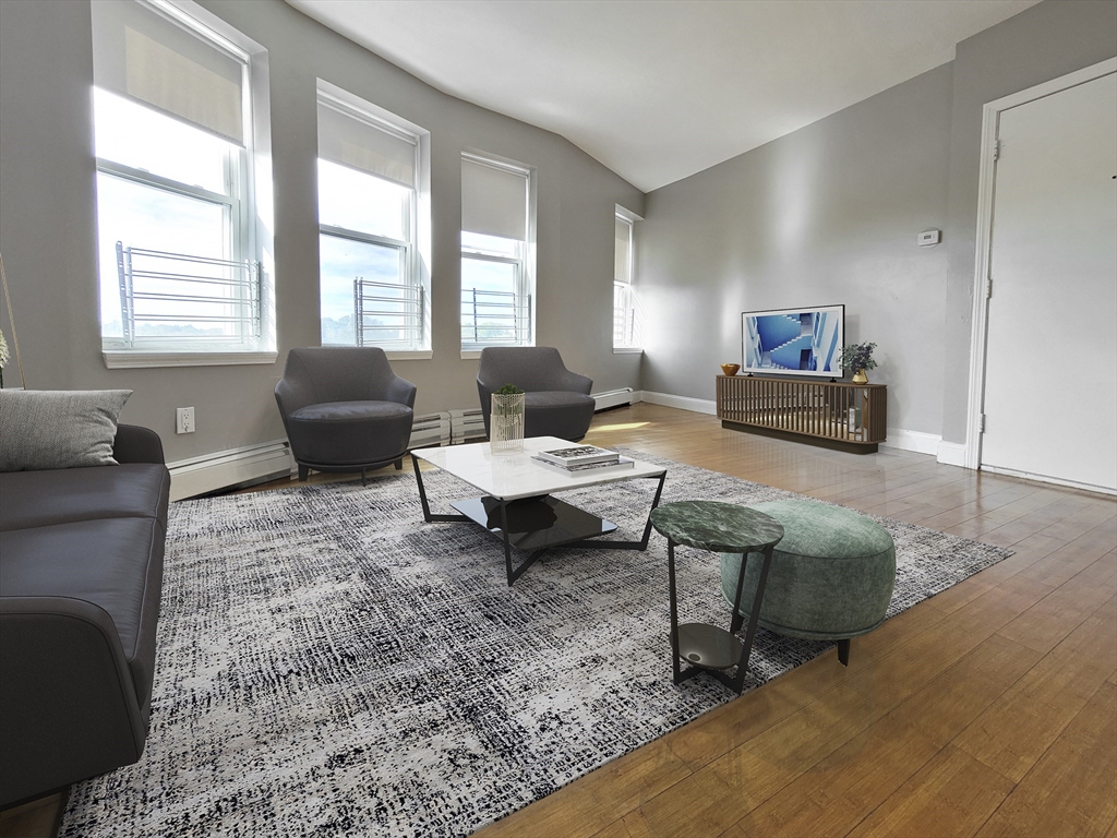 a living room with furniture rug and window