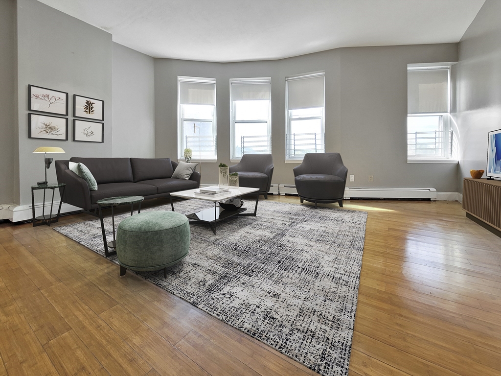 338-342 Warren Street, Unit 6 Boston, MA 02119 - Photo 2 of 7 a living room with furniture and wooden floor