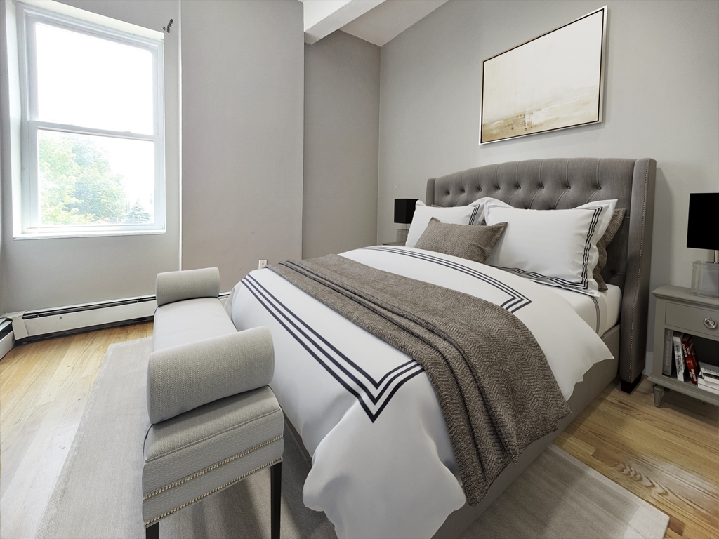 338-342 Warren Street, Unit 6 Boston, MA 02119 - Photo 4 of 7 a bedroom with a bed and a couch