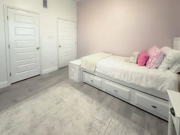 a bedroom with a bed and a dresser