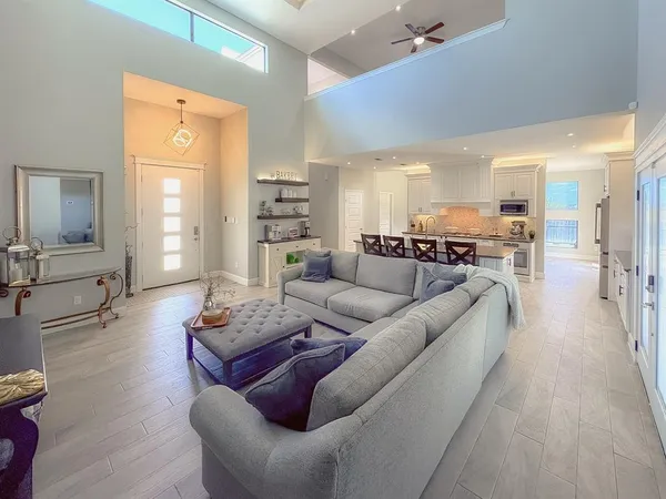 a living room with furniture and wooden floor
