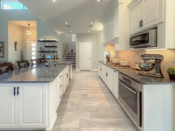 a kitchen with stainless steel appliances granite countertop a sink and cabinets
