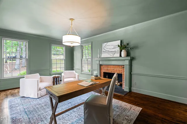 a living room with furniture a fireplace and a window