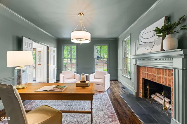 a living room with furniture a fireplace and a table