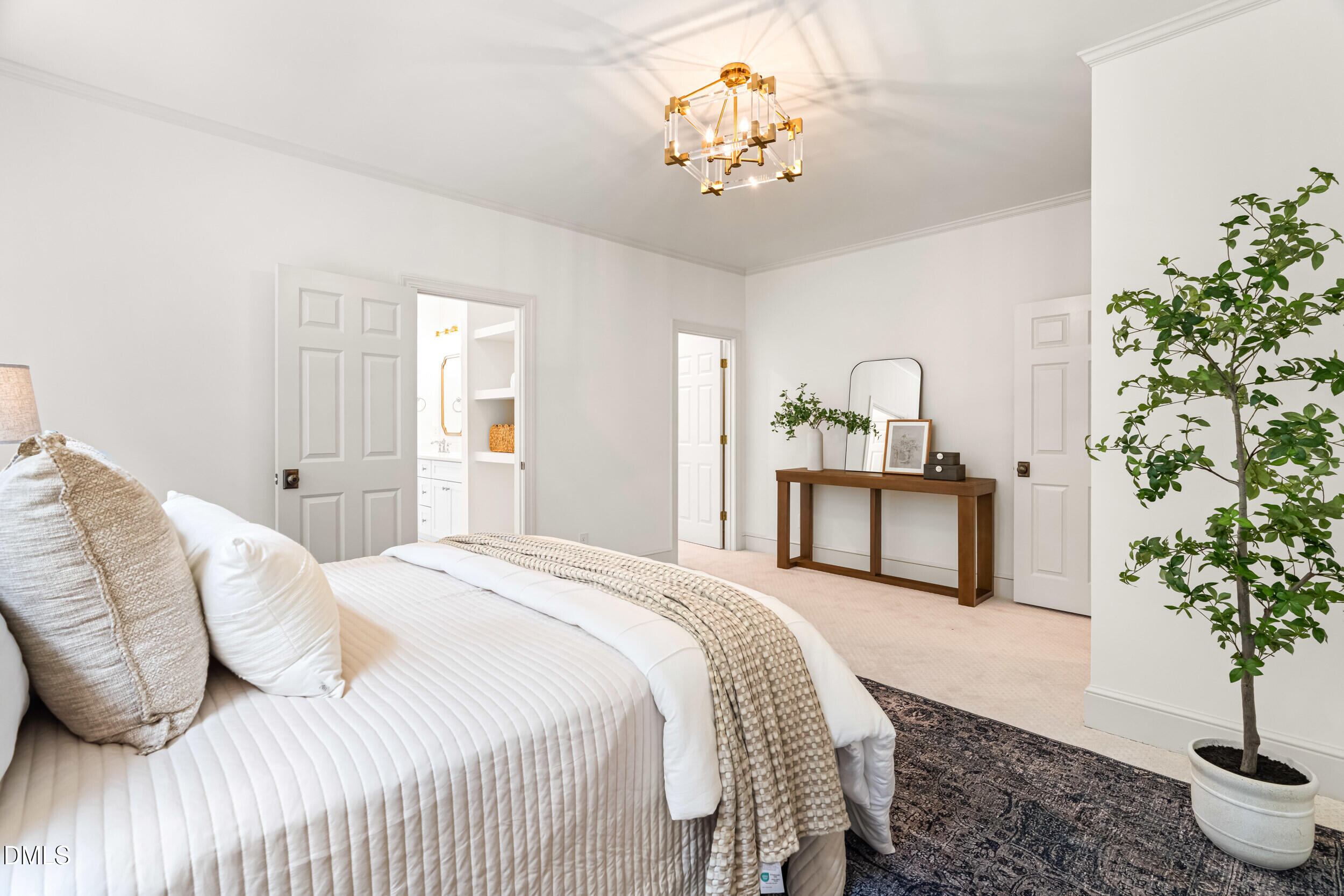 1015 Mulberry Road Clayton, NC 27520 - Photo 25 of 46 a spacious bedroom with a bed and a chandelier