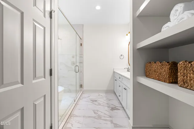 a spacious bedroom with a bed and a chandelier