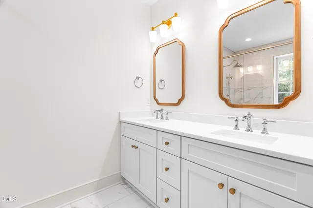 a bathroom with a double vanity sink and mirror