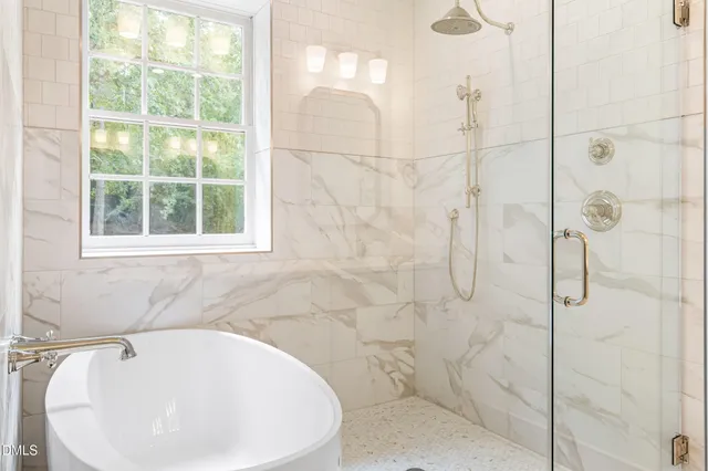 a bathroom with a bathtub and shower