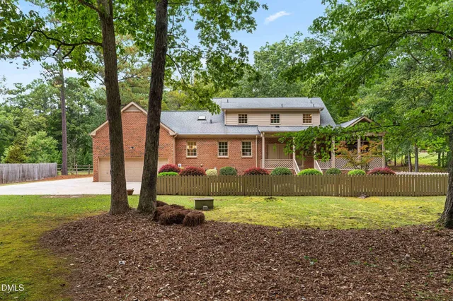 a view of garden with tall trees