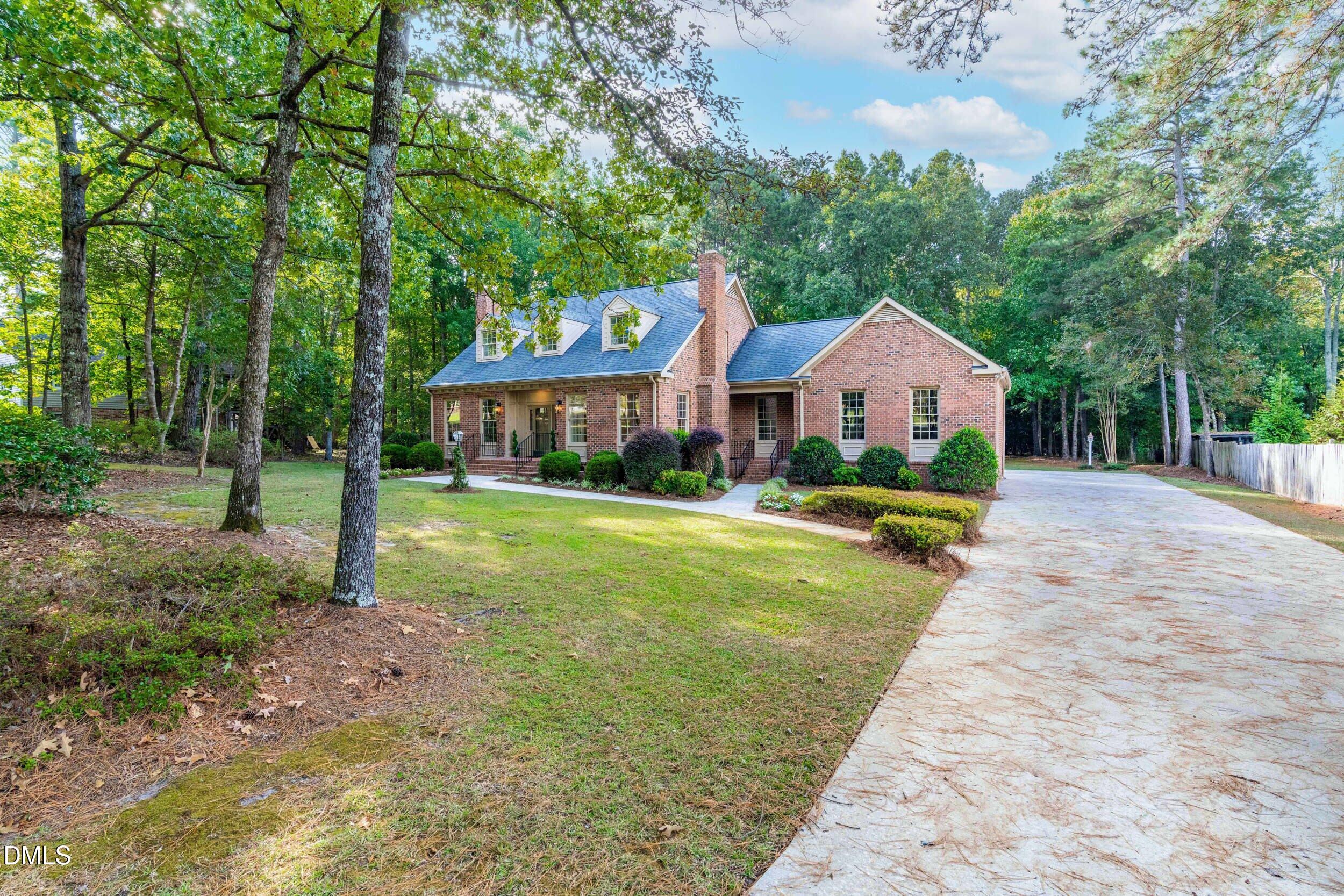 1015 Mulberry Road Clayton, NC 27520 - Photo 4 of 46 a view of a house with a yard and sitting area