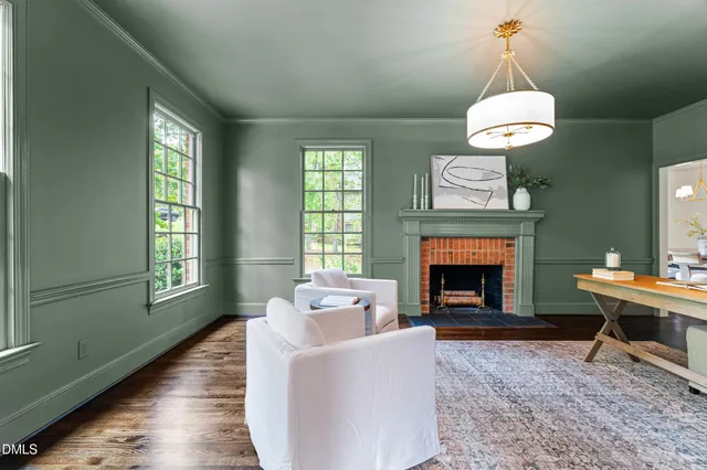 a hallway with wooden floor and windows