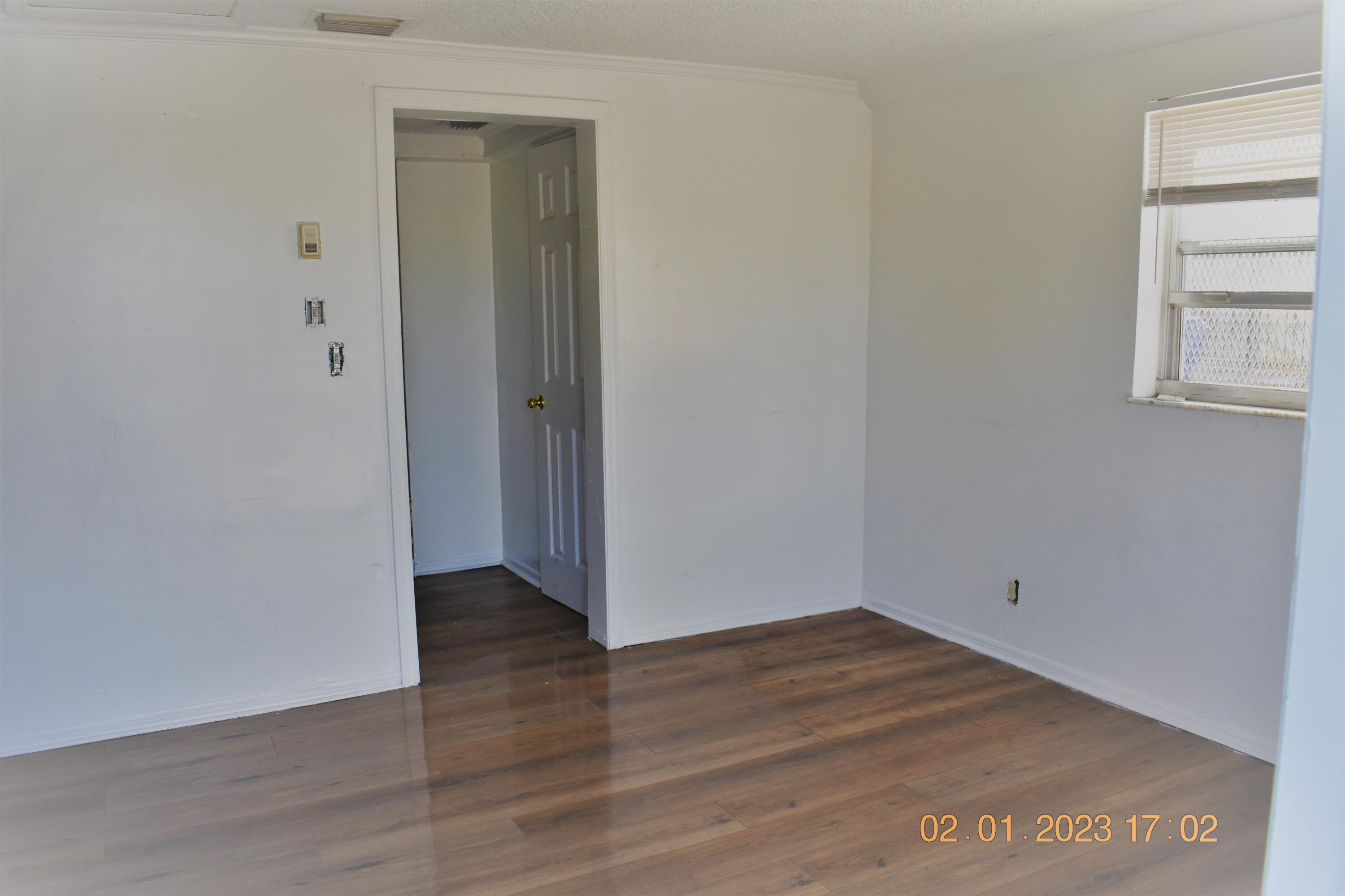 1305 West 25th Street Riviera Beach, FL 33404 - Photo 7 of 10 a view of an empty room with closet and a window