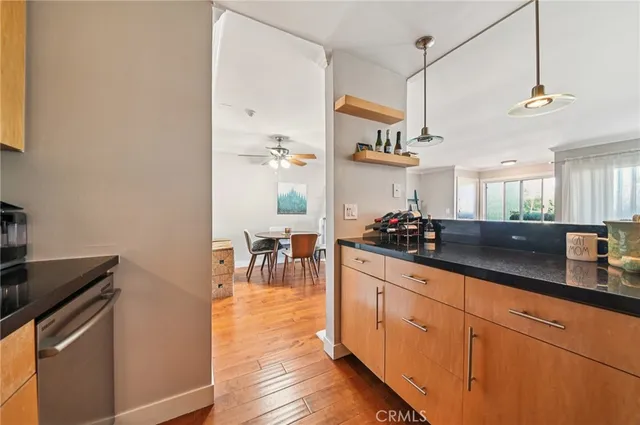 a kitchen with stainless steel appliances granite countertop a sink a stove and cabinets
