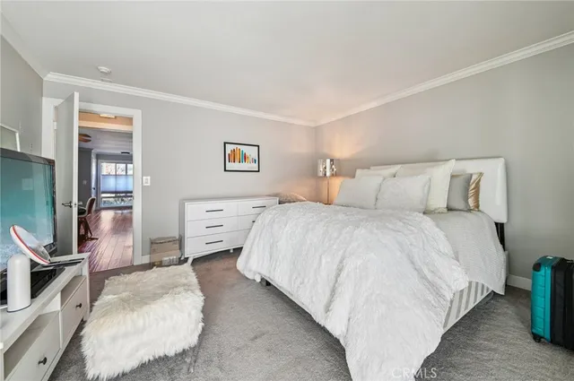 a bedroom with a bed a couch and dresser