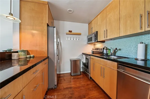 a kitchen with stainless steel appliances a sink and cabinets