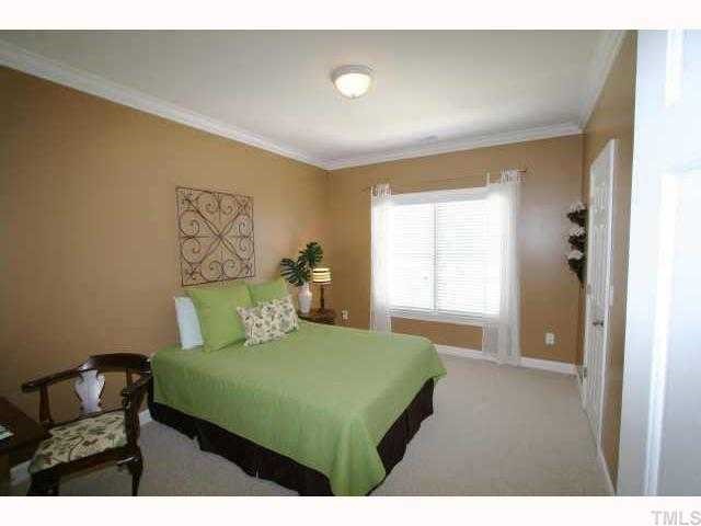 2005 Falls Farm Crossing Raleigh, NC 27614 - Photo 11 of 12 a bedroom with a bed and a chair