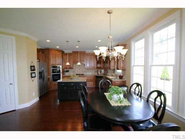 2005 Falls Farm Crossing Raleigh, NC 27614 - Photo 4 of 12 a dining room with furniture and a chandelier