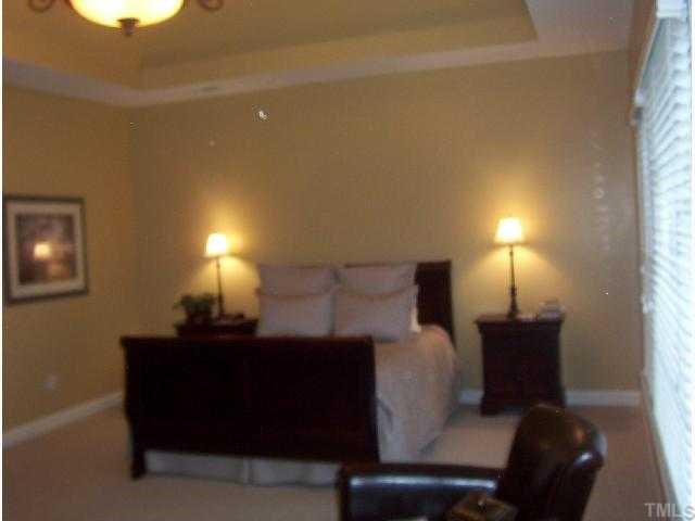 2005 Falls Farm Crossing Raleigh, NC 27614 - Photo 7 of 12 a bed room with a bed and a lamp