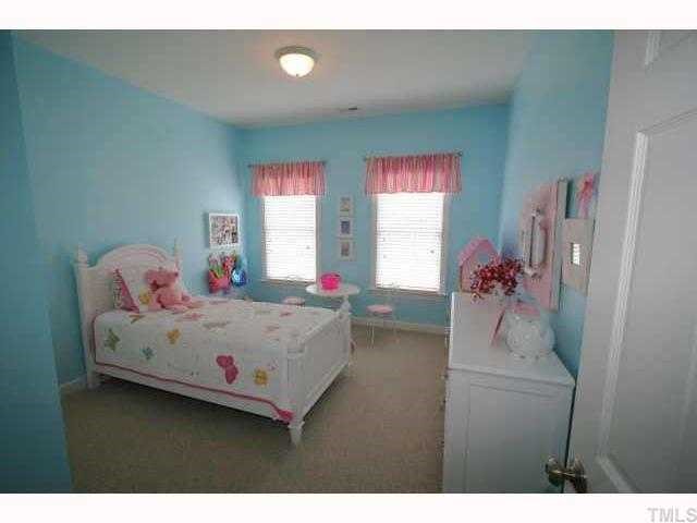 2005 Falls Farm Crossing Raleigh, NC 27614 - Photo 10 of 12 a bedroom with a bed and a chandelier