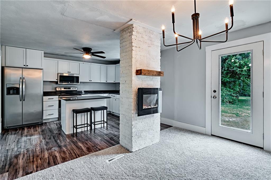 408 20th Street Beaver Falls, PA 15010 - Photo 11 of 27 a kitchen with kitchen island a counter top space a sink appliances and cabinets